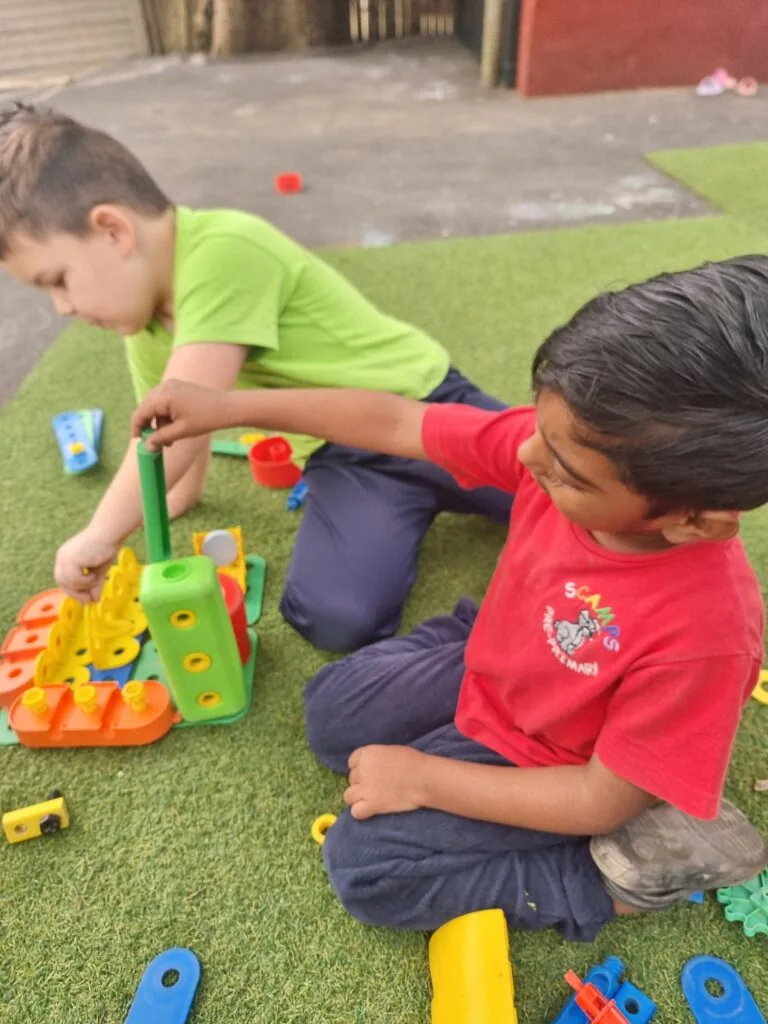 Little hands building with colourful blocks at Scamps daycare Queensburgh