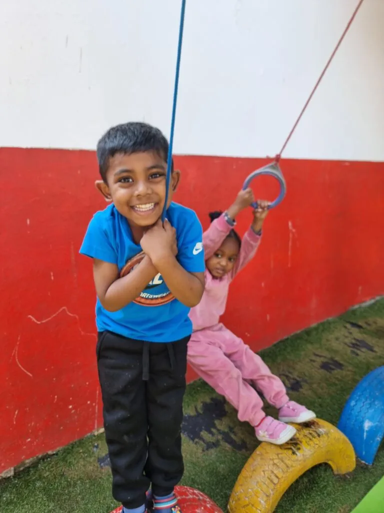 Happy children on the play equipment at Scamps daycare Queensburgh